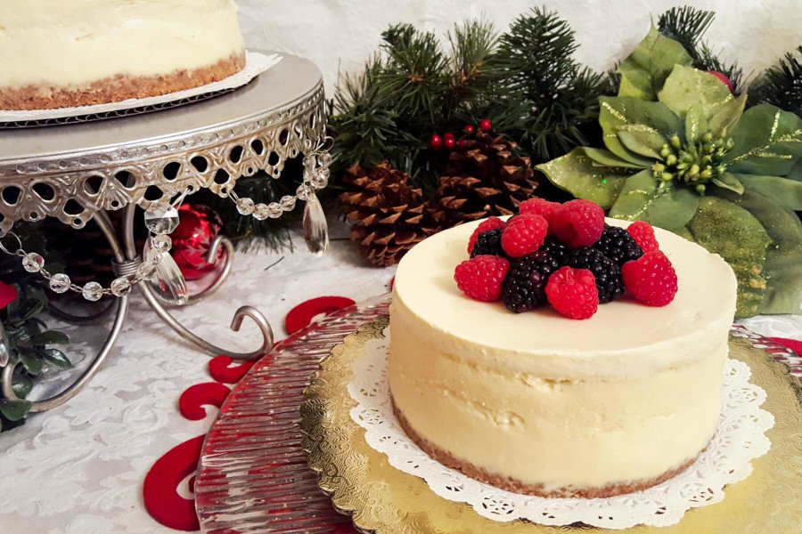 Cake on plate with raspberry on top.